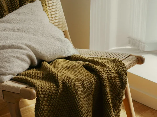 A comfortable chair and blanket representing meaningful household items to keep