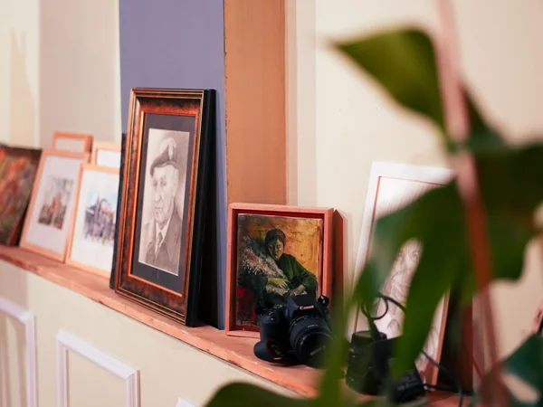 Framed photographs and artwork representing household items that may be sold